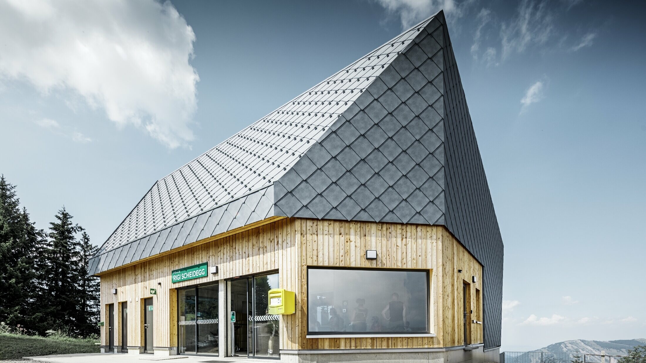 Rigi Railway Scheidegg mountain station in Goldau, Switzerland. The roof and part of the façade were covered with the 44 x 44 rhomboid roof and façade tile in P.10 stone grey.