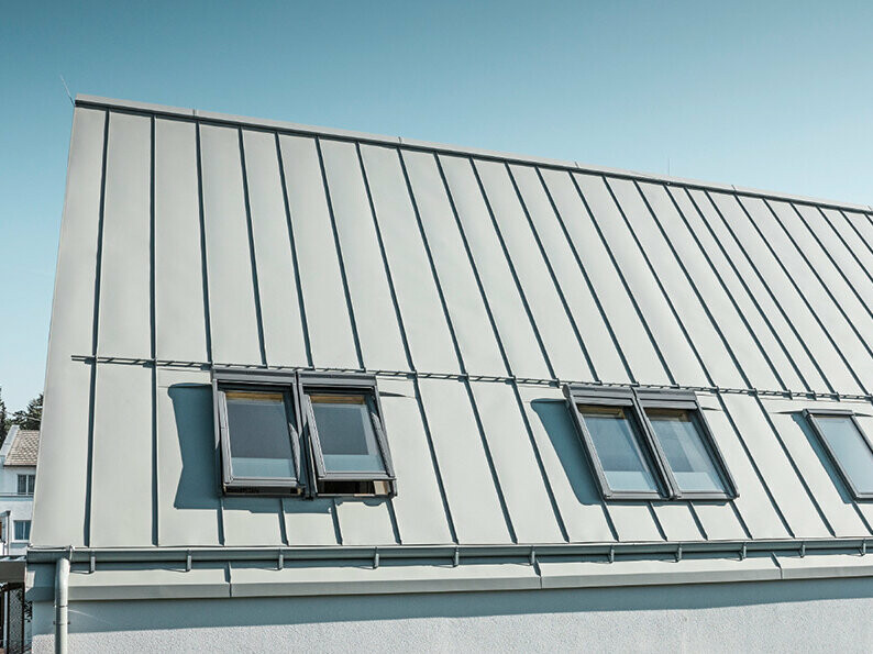 PREFALZ seamed roof in P.10 zinc grey with roof windows