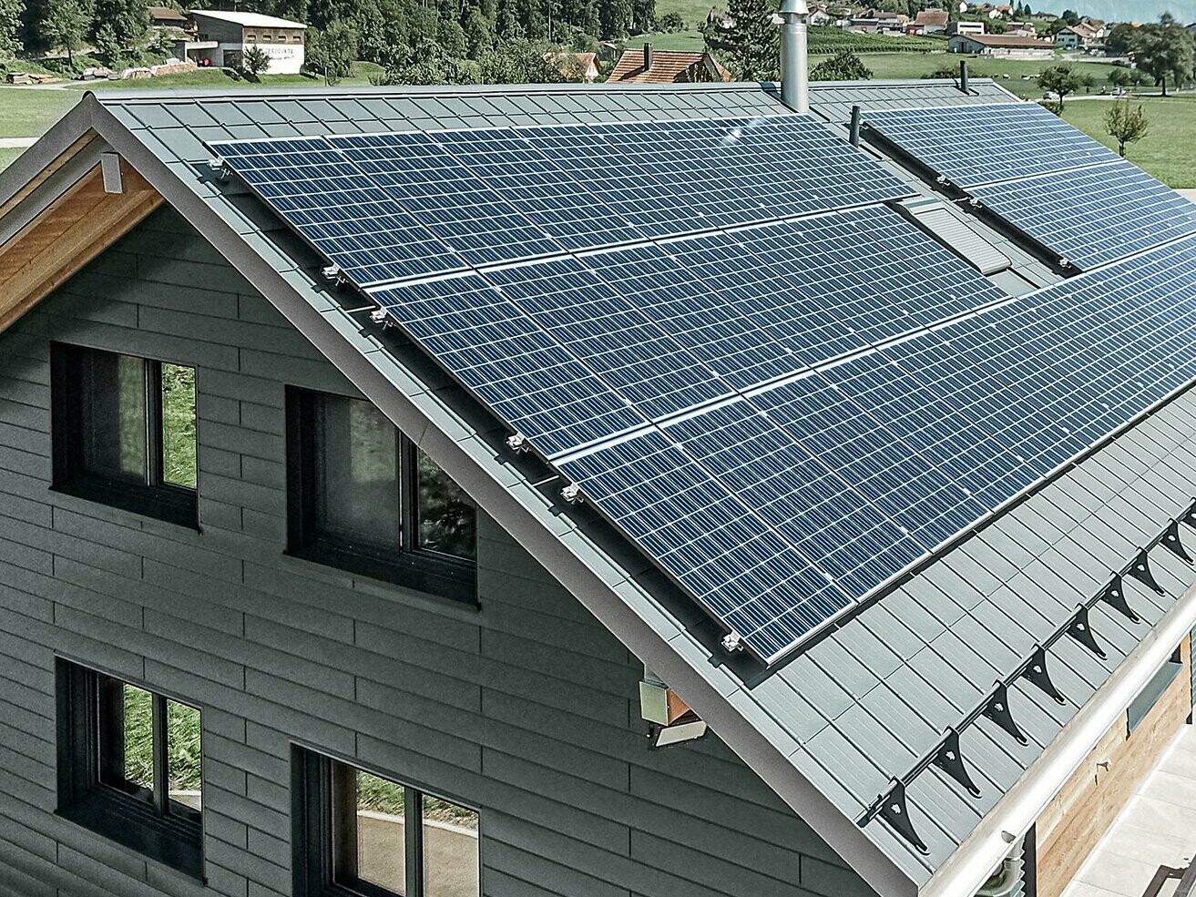 Solar panel system mounted on PREFA roof with solar brackets and profile rails for a secure hold.