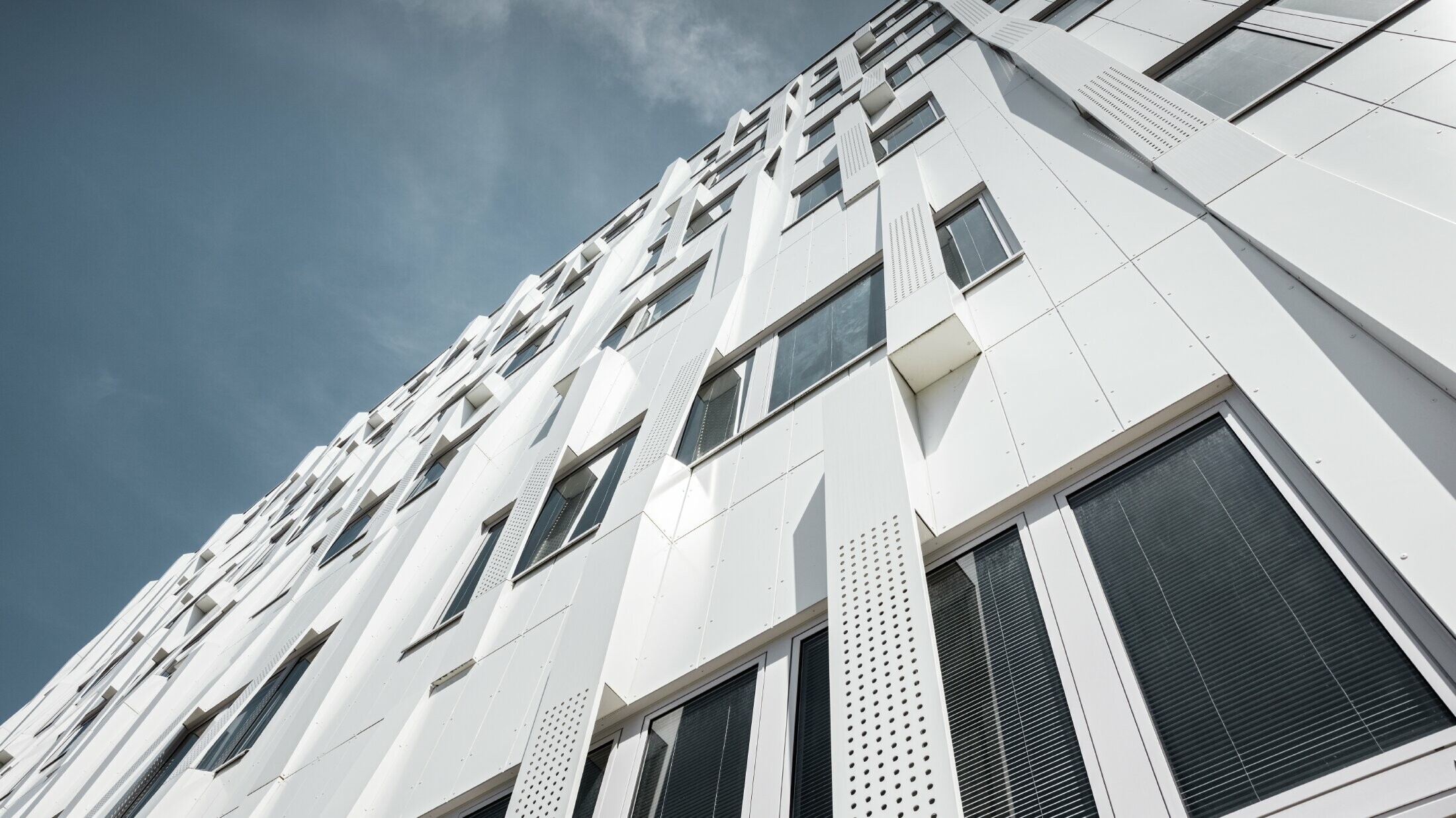 Special 3D façade, with perforated aluminium composite panel cassettes and normal PREFA composite panels in pure white, PREFA cassette façade