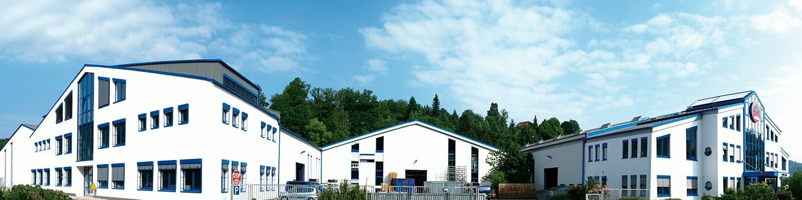 PREFA company building with white façade and blue windows